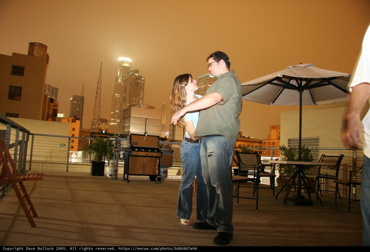 Rooftop Romance Dancing Under Smoky City Skies