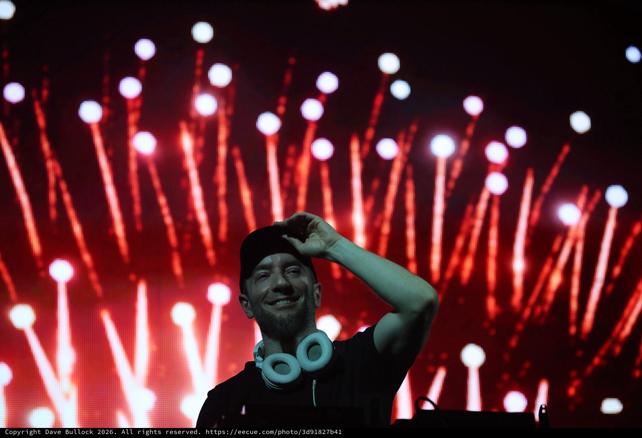 DJ Performs Under Dramatic Red Stage Lights