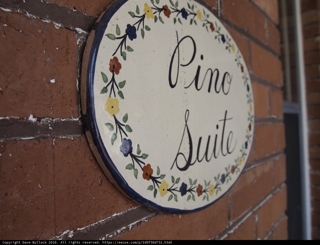 Pine Suite Sign on Brick Wall