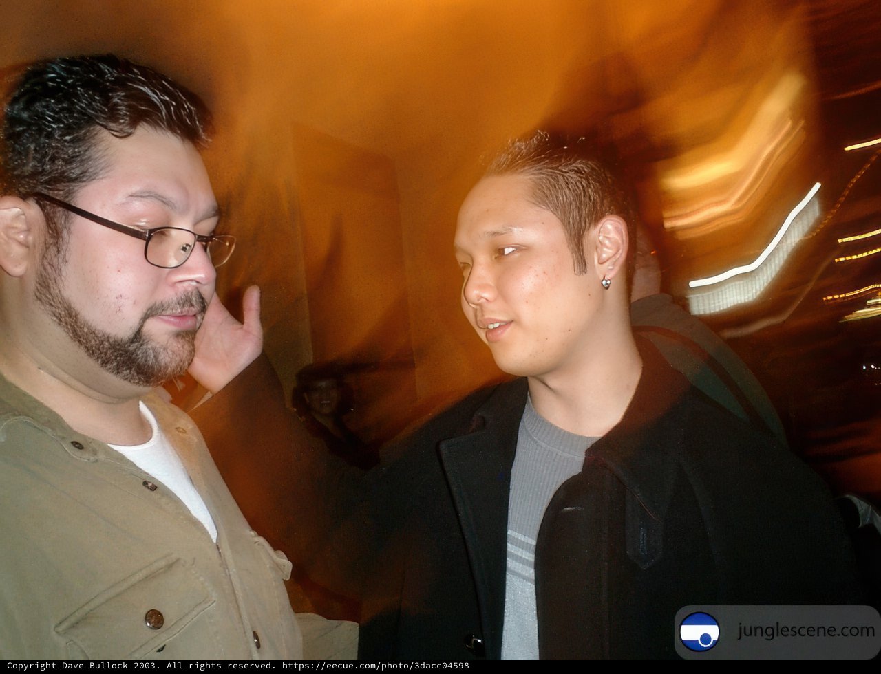 Two Men in Urban Nighttime Setting
