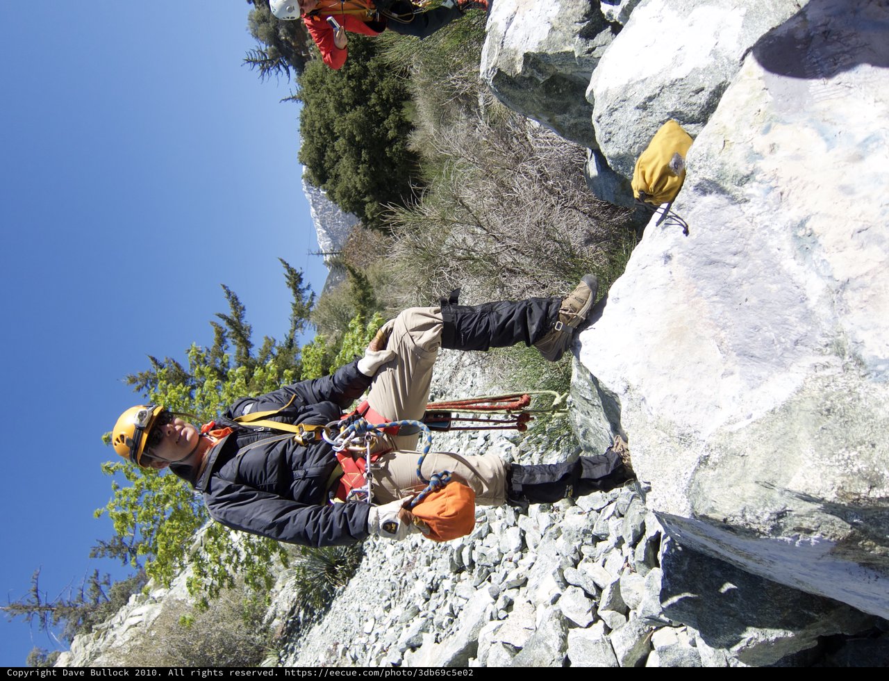Mountain Rescue Climber Surveys Rocky Terrain Below