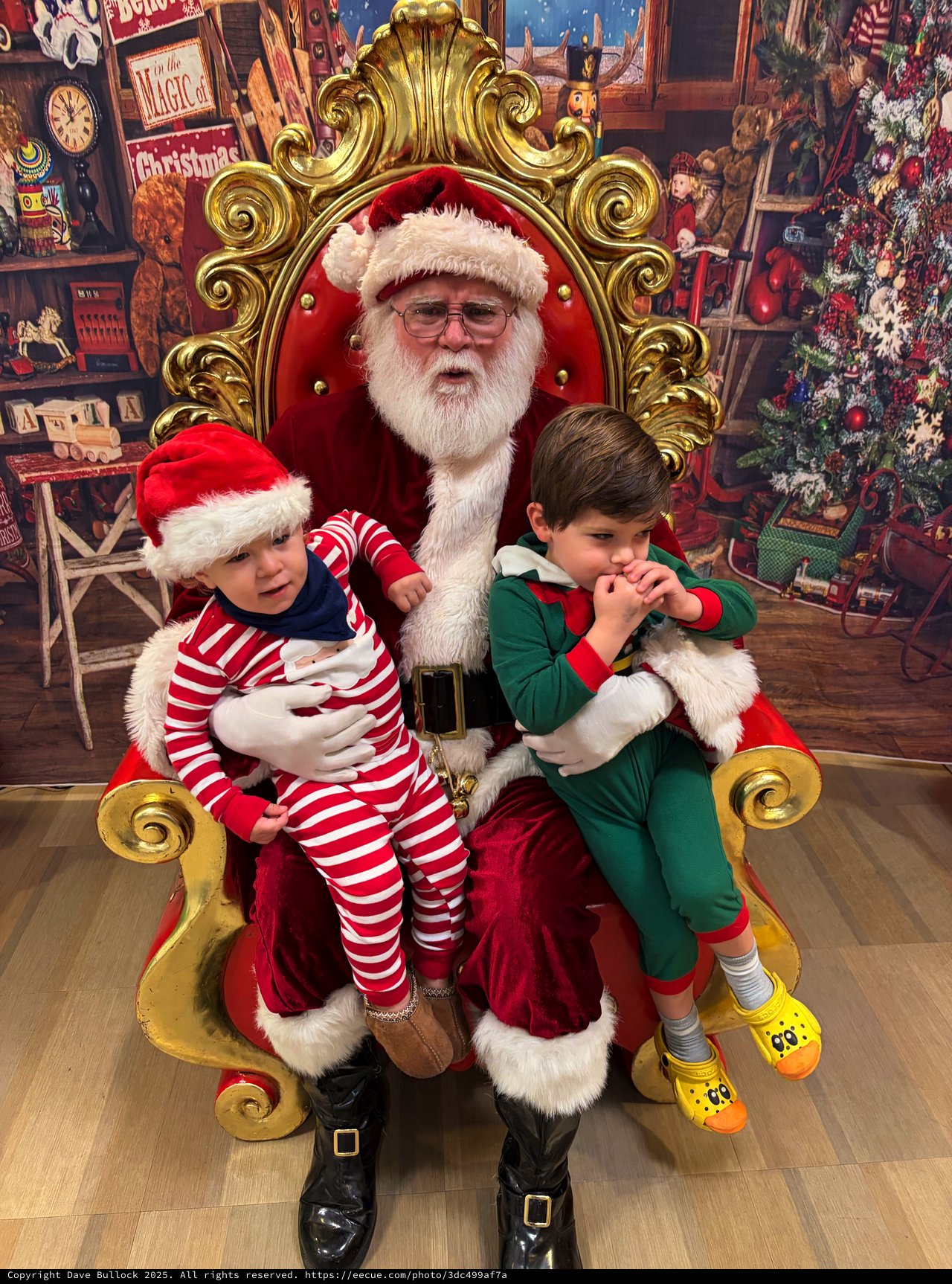 Two Boys Visit Santa in His Festive Workshop Throne