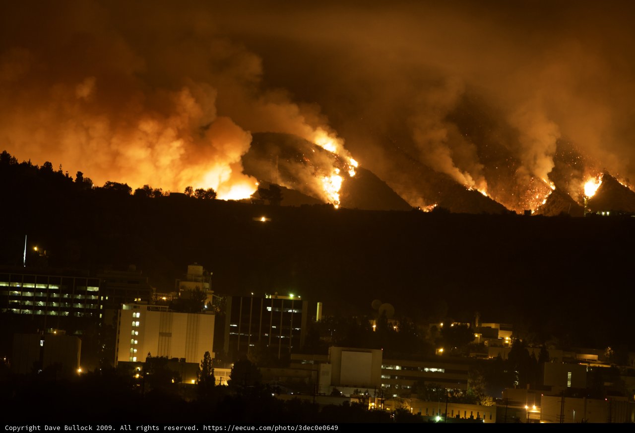Flames Illuminate City Night Sky