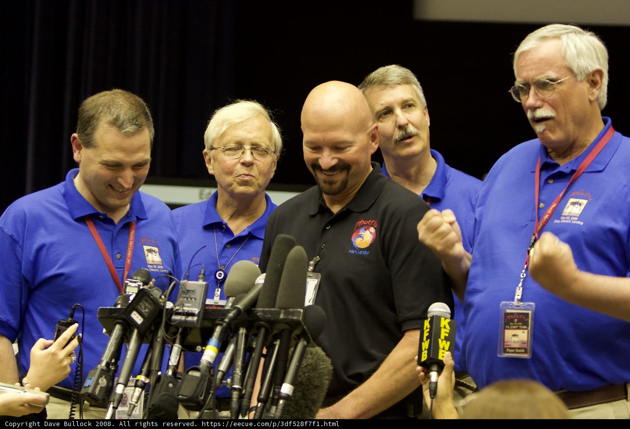 Blue-Shirted Men at Post-Interview Press Conference