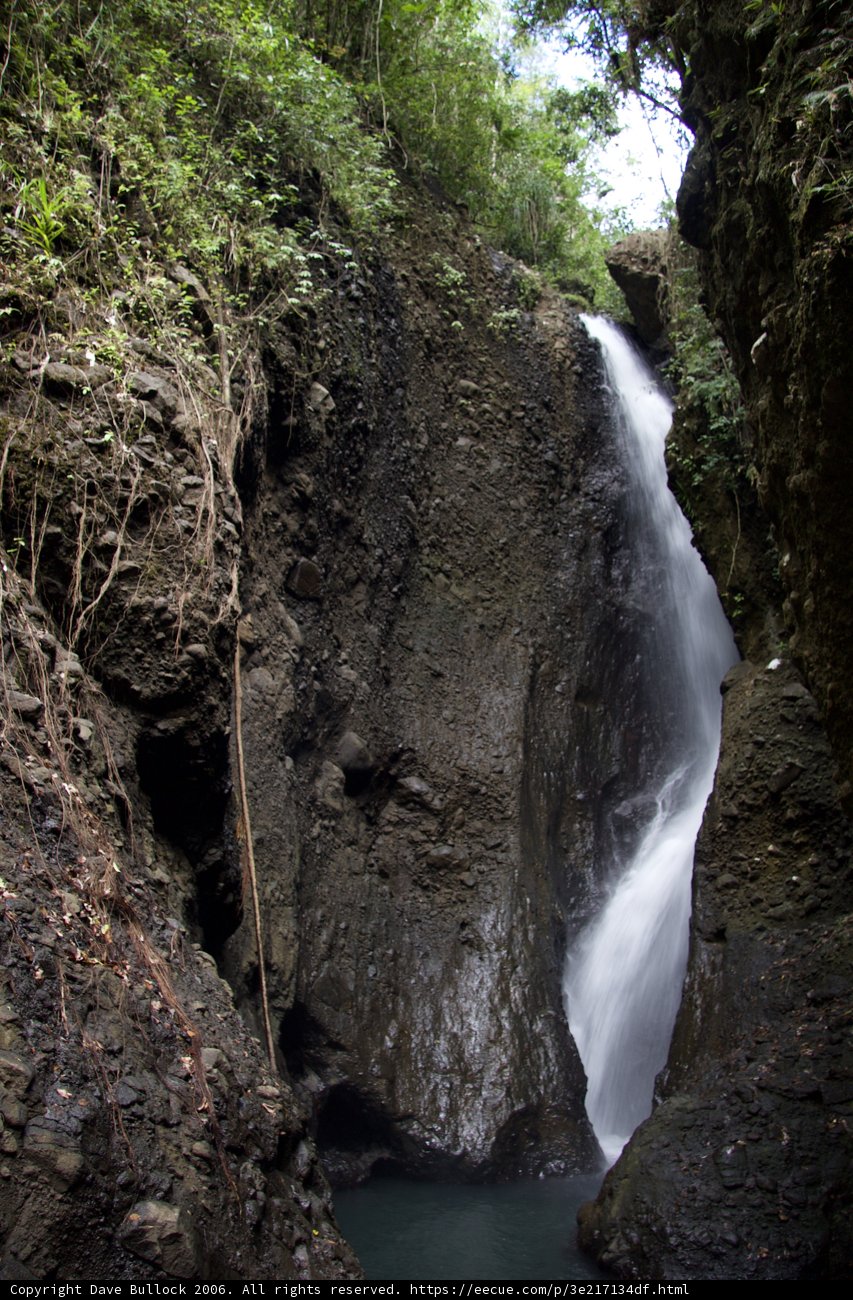 Stunning Waterfall Amidst Lush Greenery and Rocks