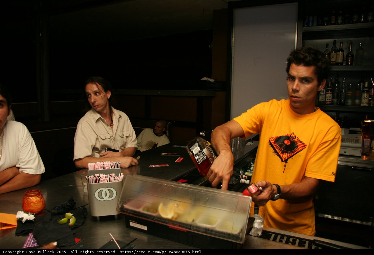 Yellow-Shirted Bartender at Busy Pub