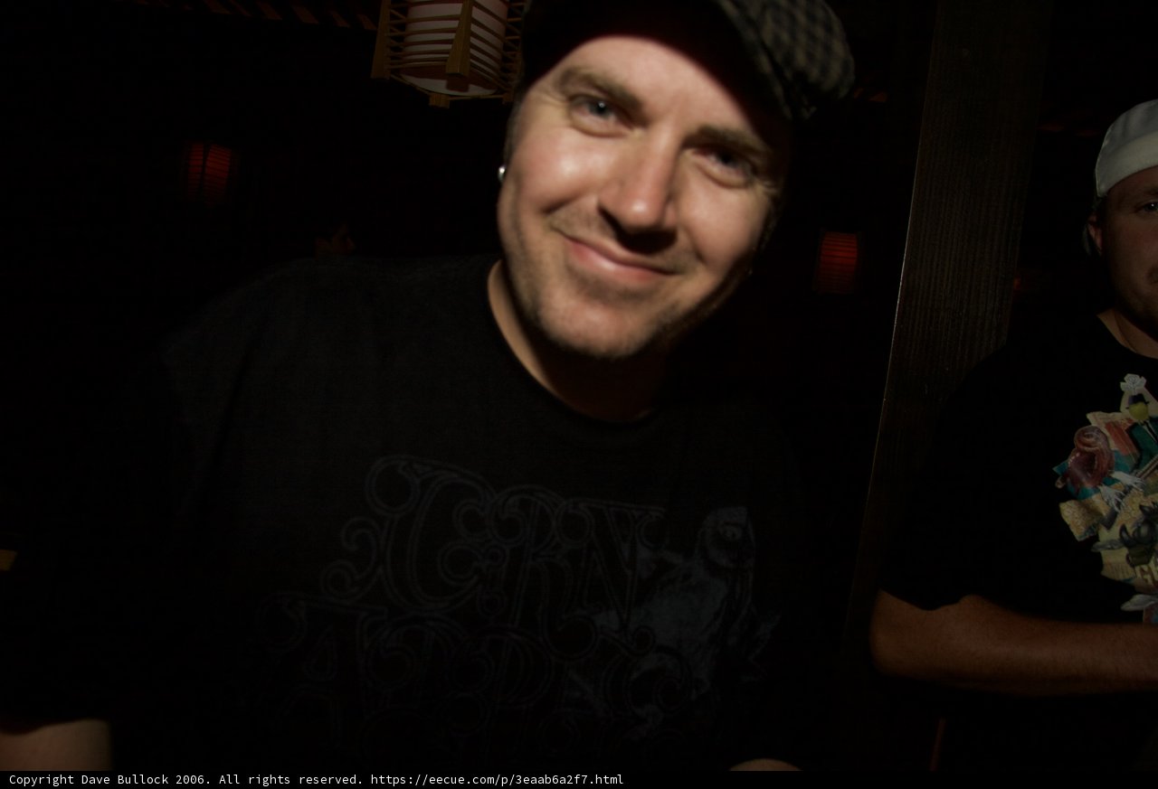 Smiling Duo in Black Shirts and Hats