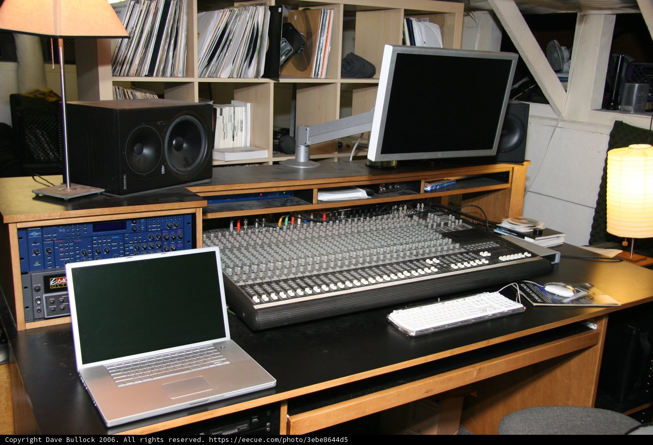 Black Desk with Computer Equipment and Speakers