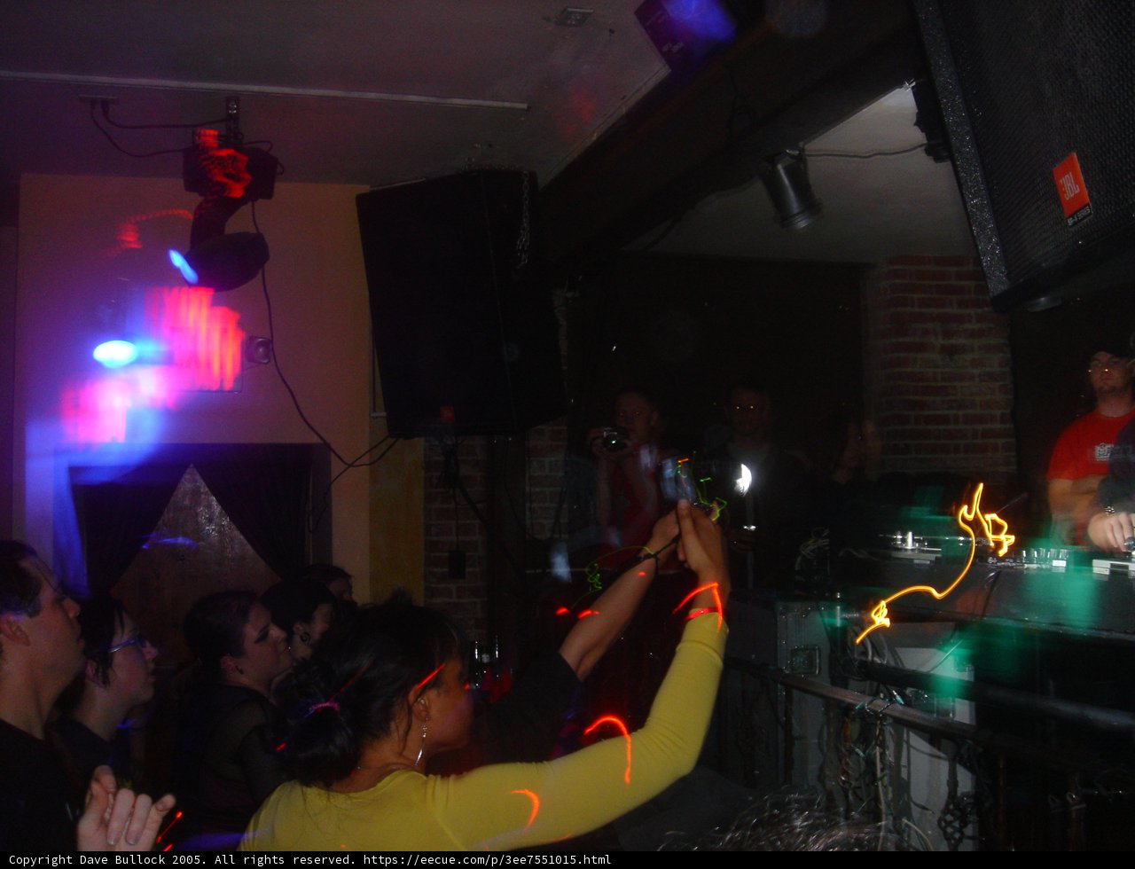 Woman in Yellow Shirt Shines in Urban Nightclub