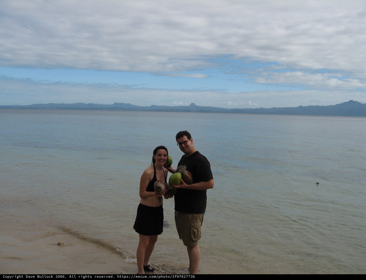 Couple Celebrating Fresh Coconuts on Fijian Beach