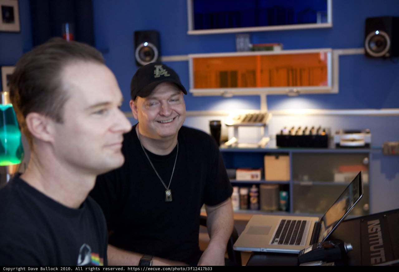 Two Men Working on Laptop in Studio