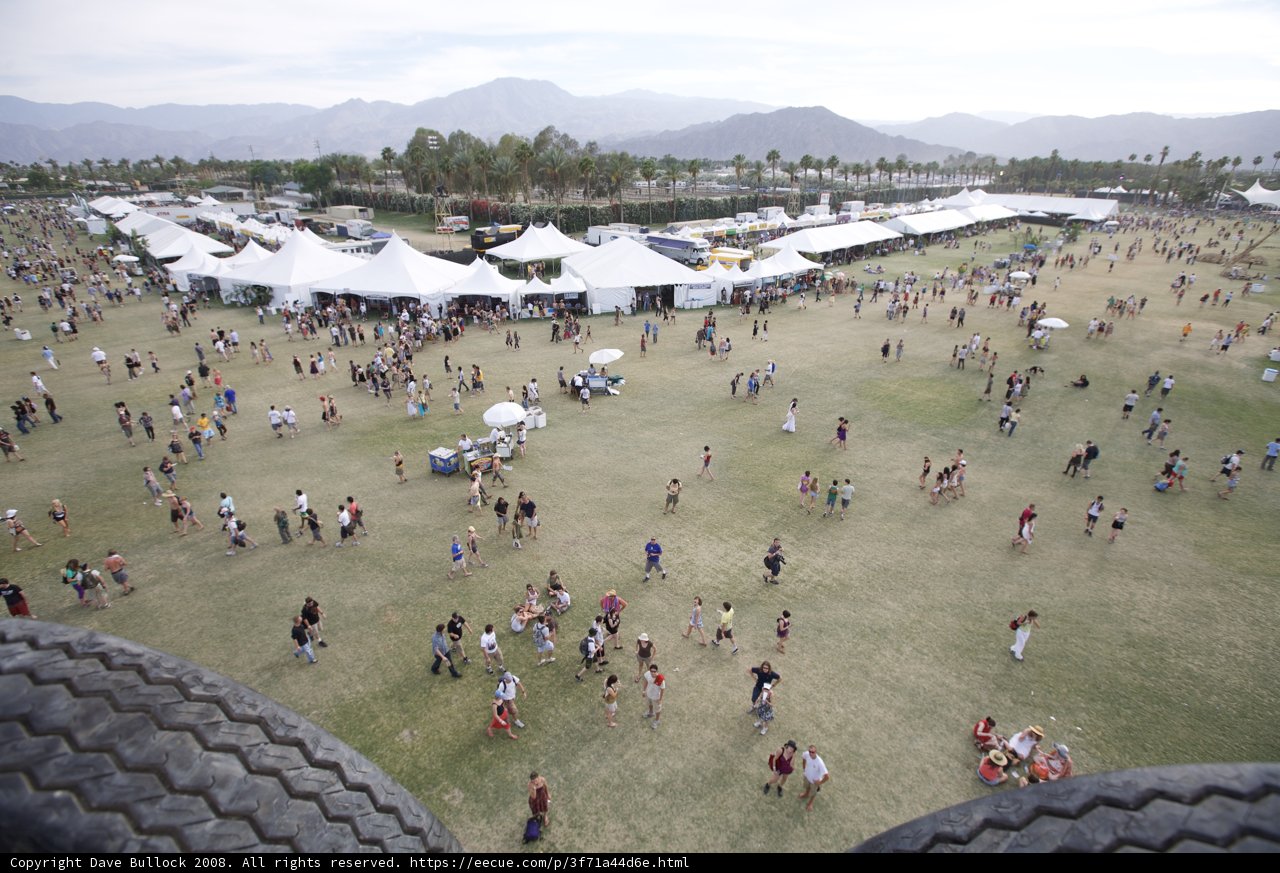 Festival-goers gather for a show on the grassy hill