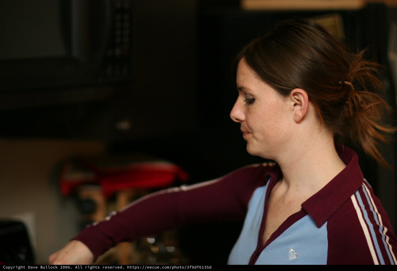 Woman in Profile Reaching Forward in Kitchen
