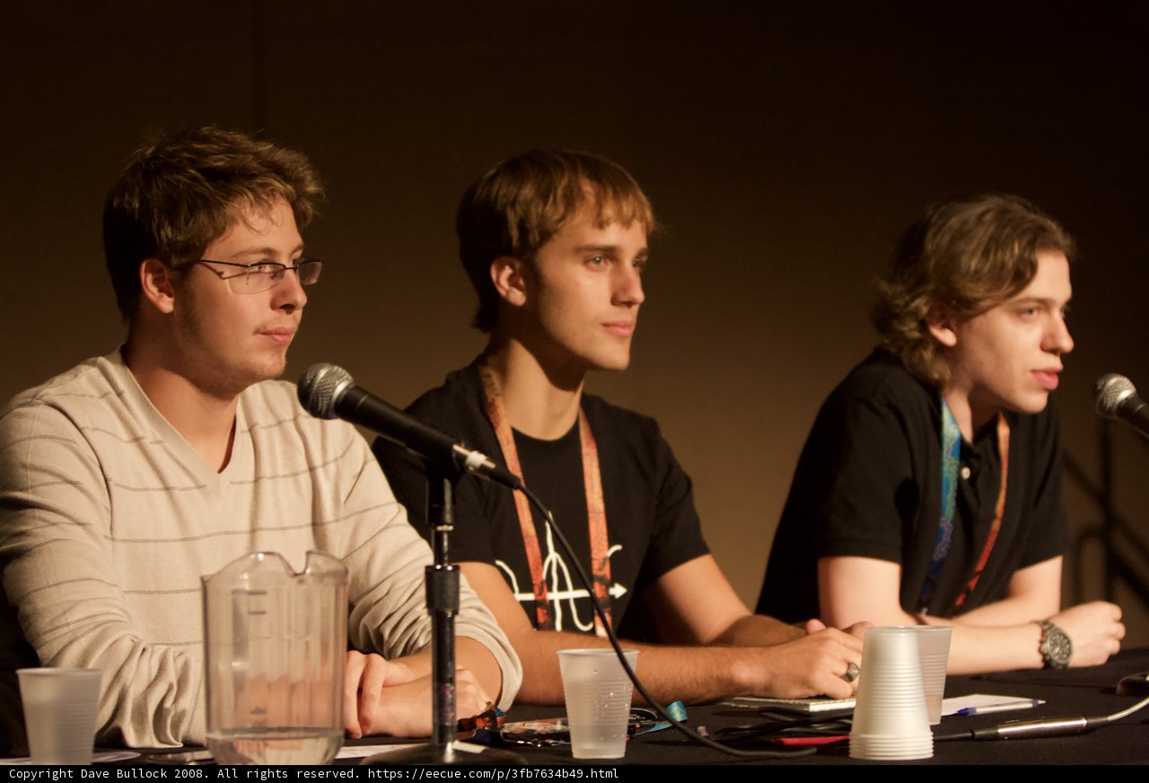Three Men Engaged in Discussion