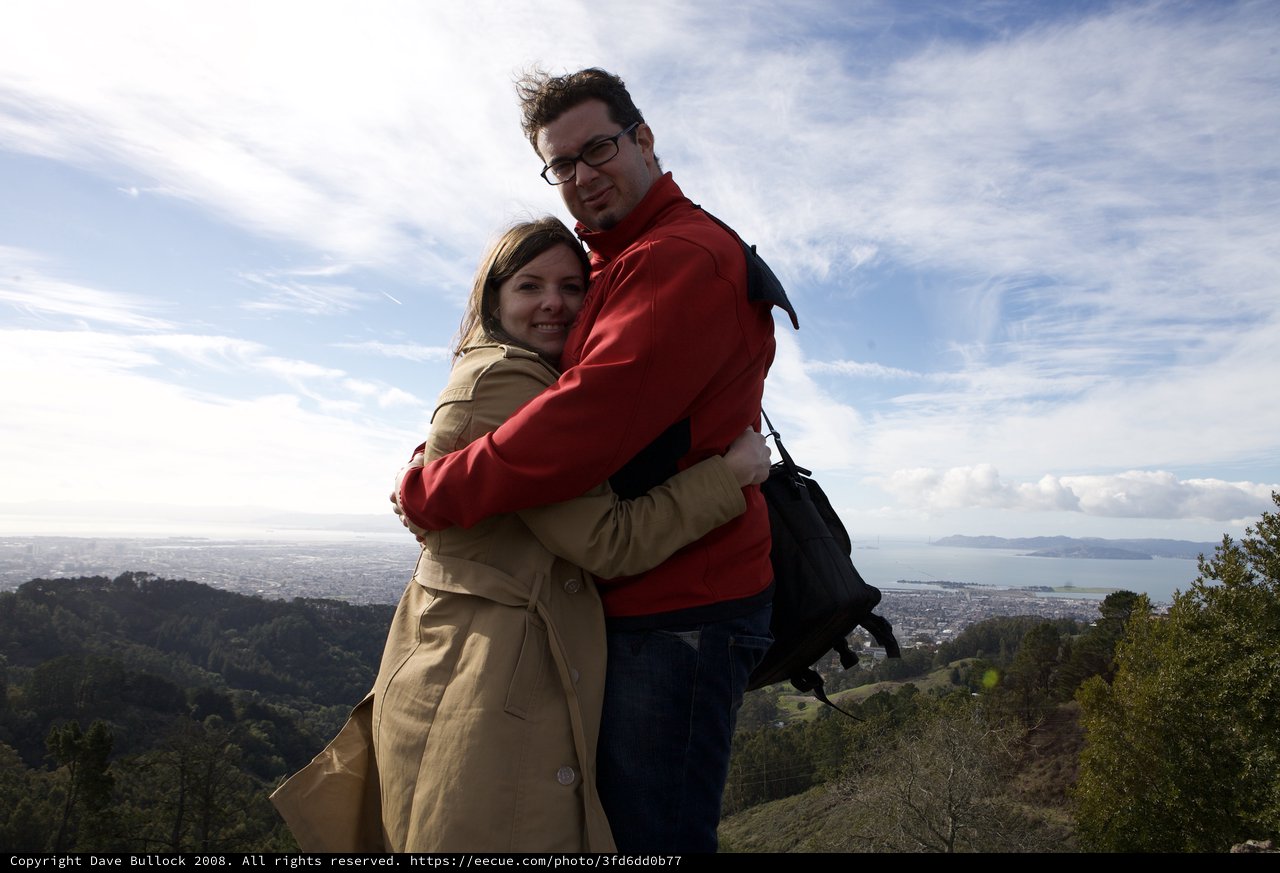 Couple Embracing Atop Hill Overlooking San Francisco Bay