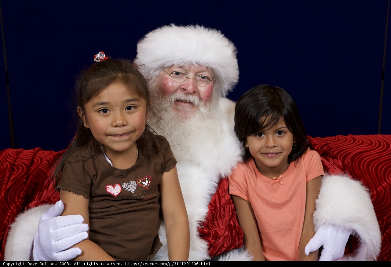 Santa Claus and Two Girls on a Couch