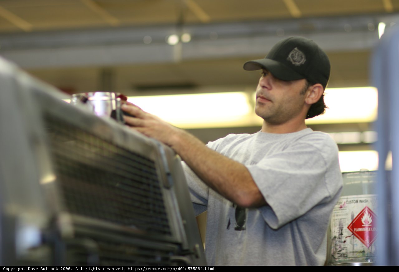 Gray Shirted Man Sporting Baseball Cap