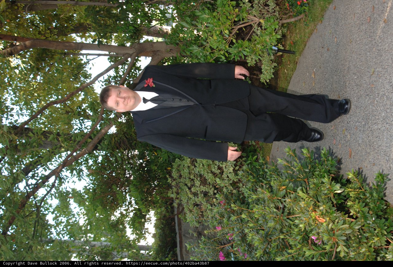 Dapper Groom Walking Garden Path Before Wedding