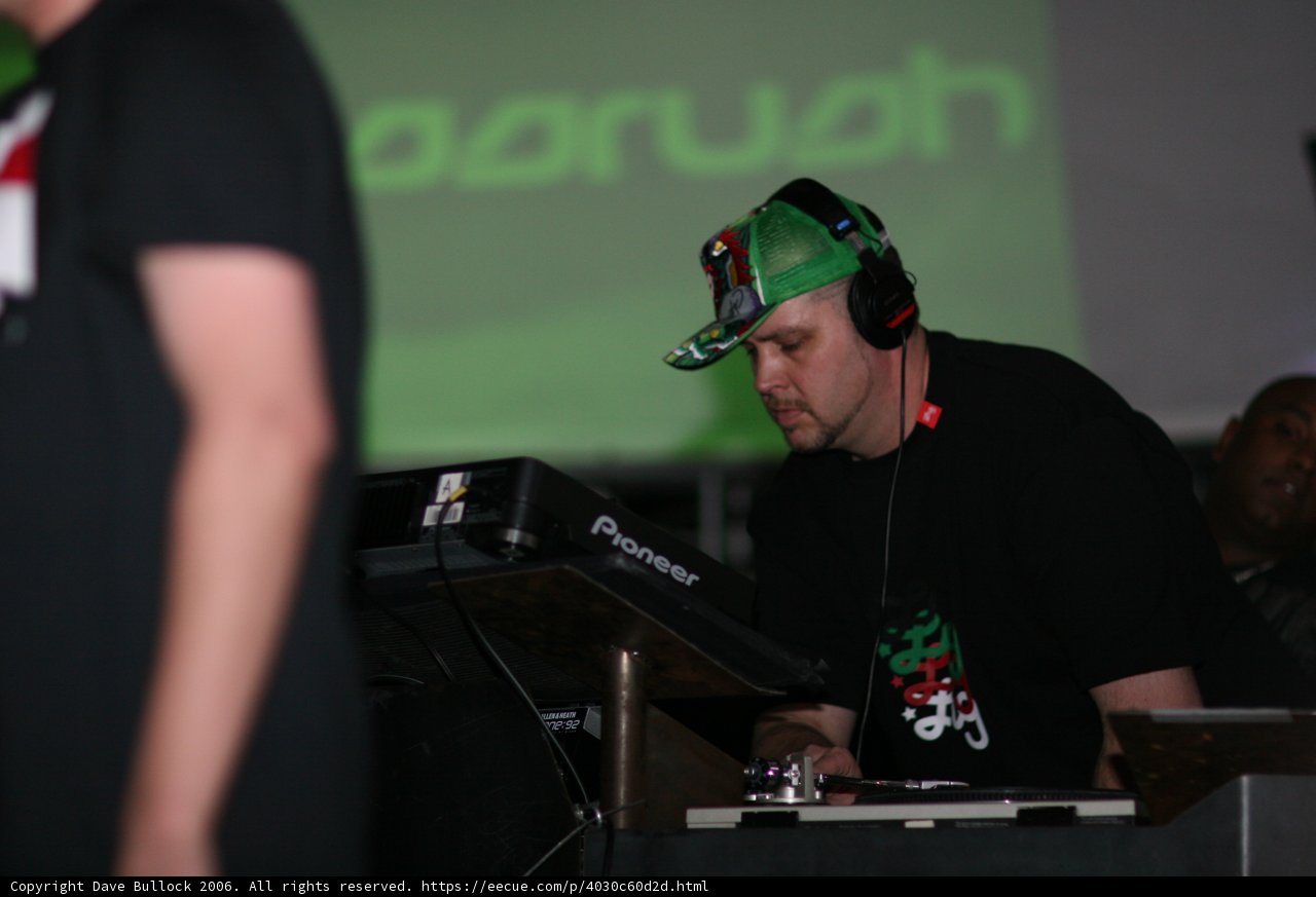 DJ Sam R Performing with Headphones and Green Cap