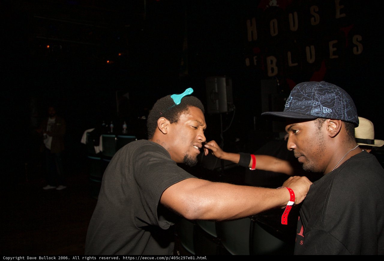 Two Men Sporting Hats and Jewelry