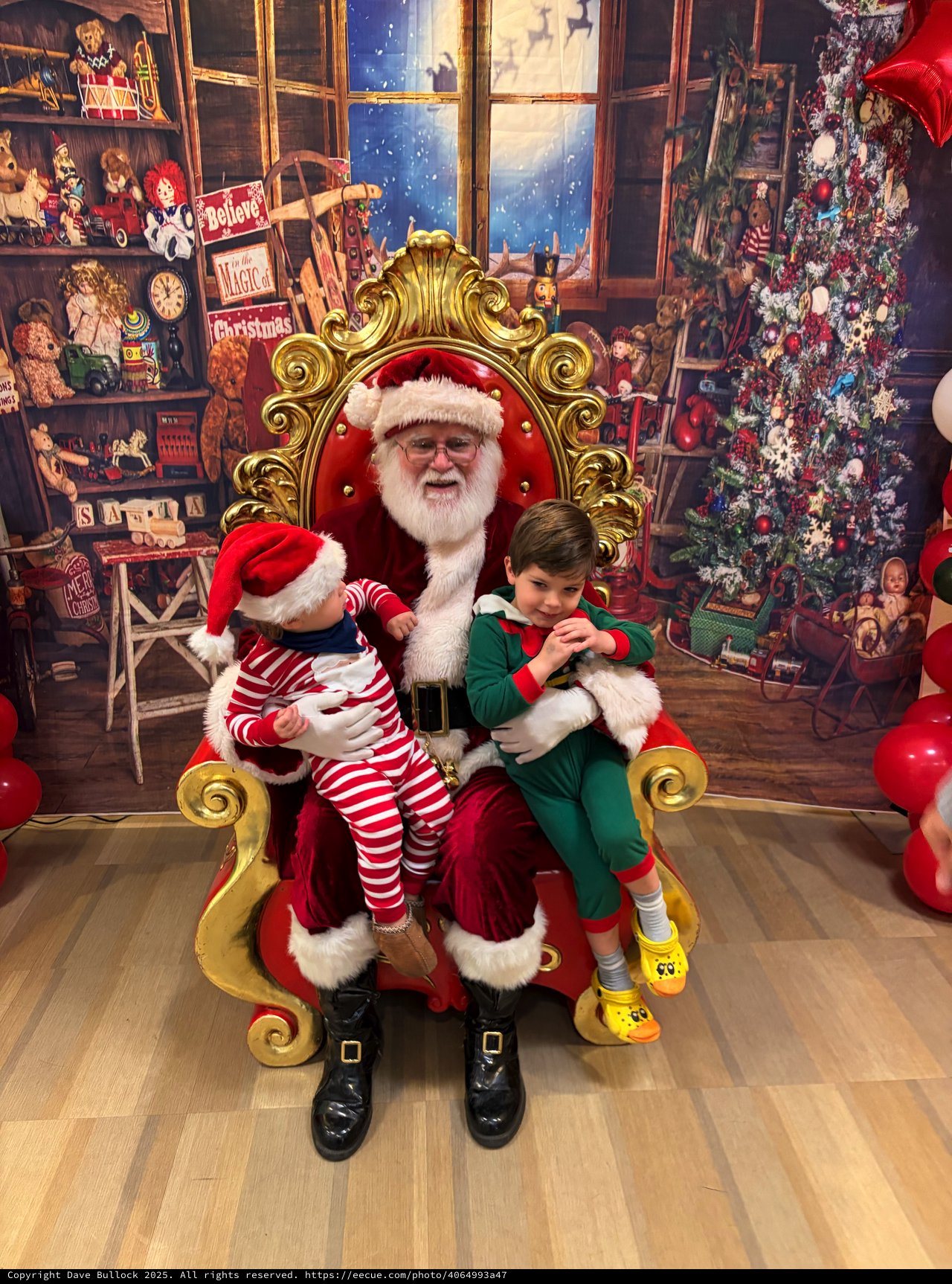 Two Children Visit Santa in His Workshop Grotto