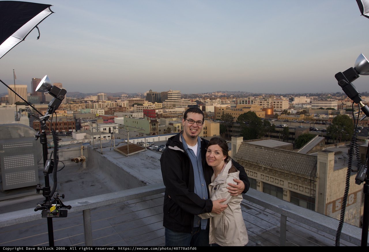 Couple Embracing on Urban Rooftop at Dusk