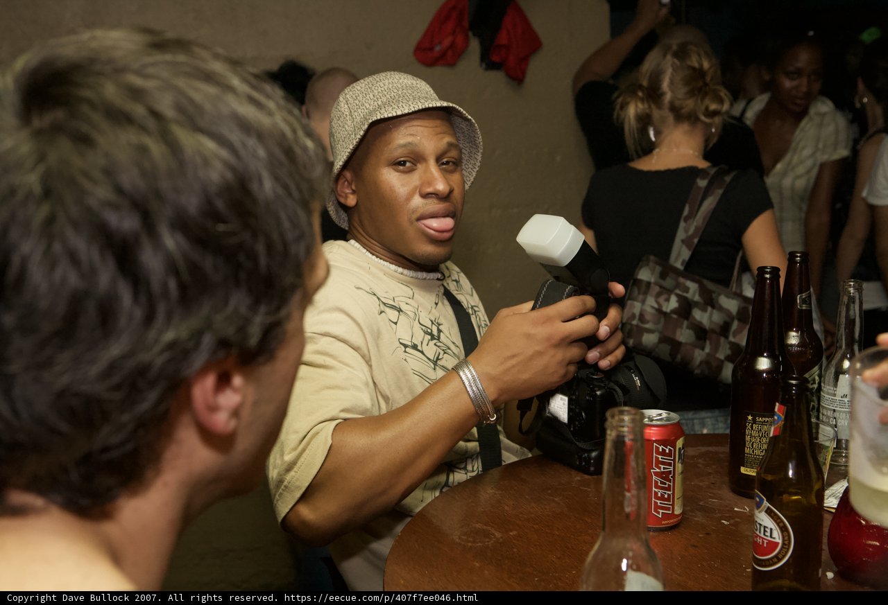 Two Men Sharing Drinks and Conversation