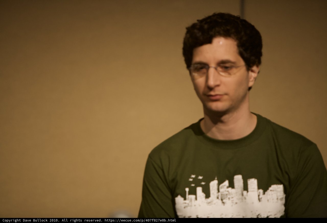 Green Shirt Guy in Front of Wall