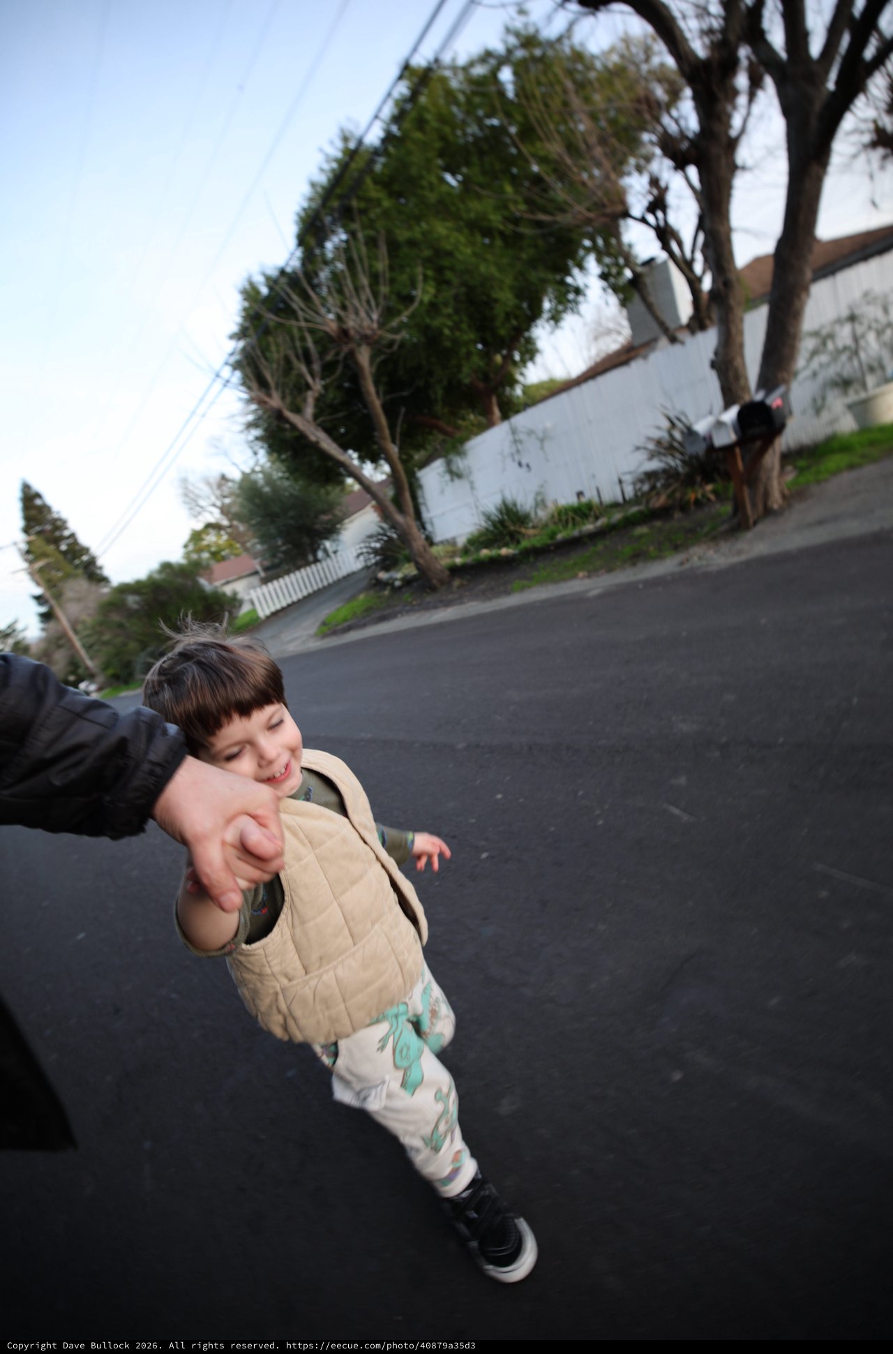 Joyful Child Holding Hand on Suburban Street Walk