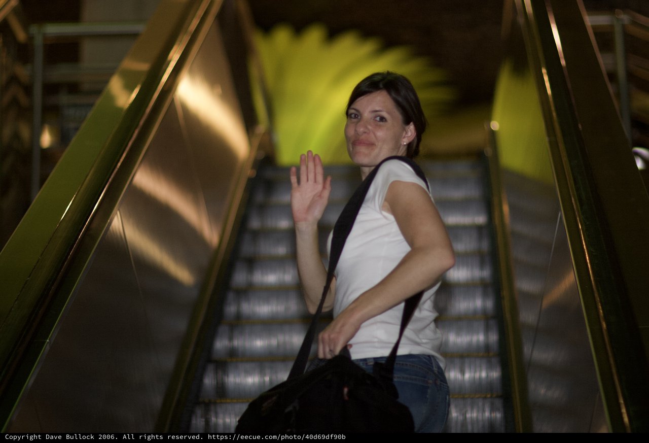 Farewell Wave on the Escalator at Night