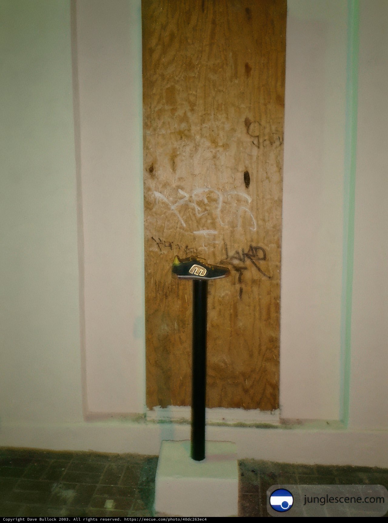Graffiti on Wooden Door with White Pedestal