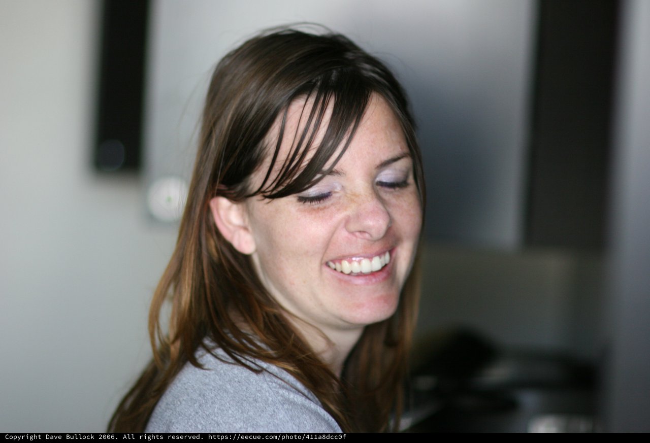 Joyful Woman Laughing in Casual Indoor Setting