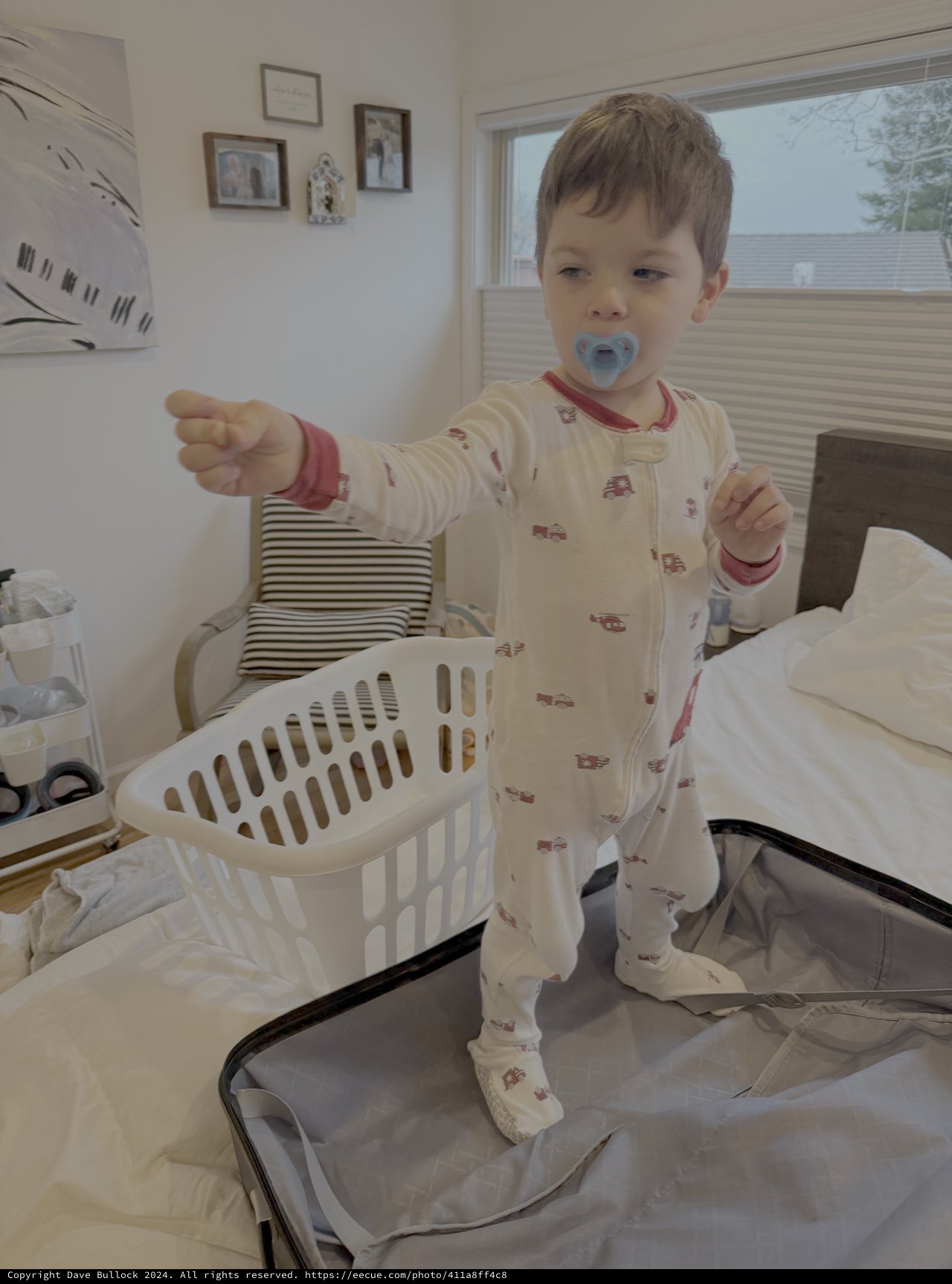 Toddler Helper with Laundry Basket on Bed