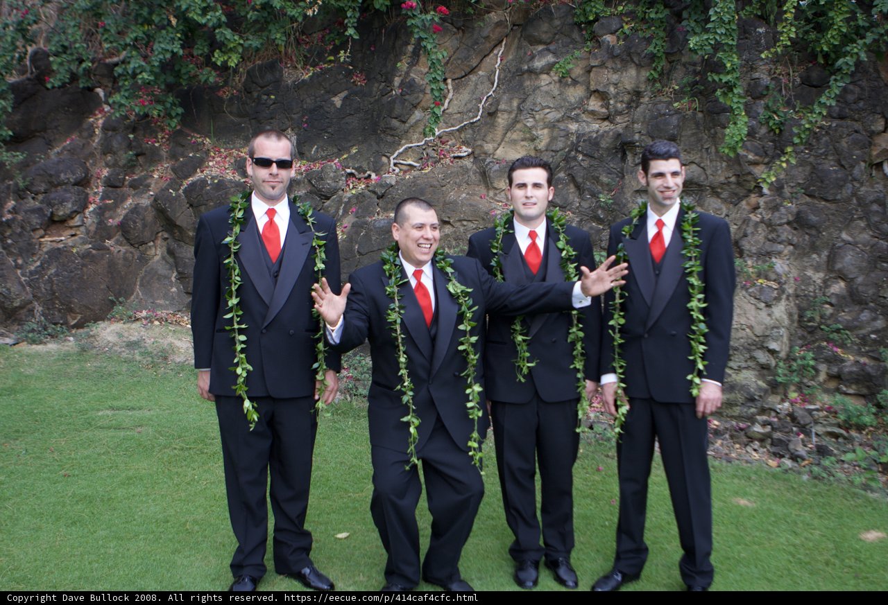 Men in Formal Wear Stand before a Rock Wall
