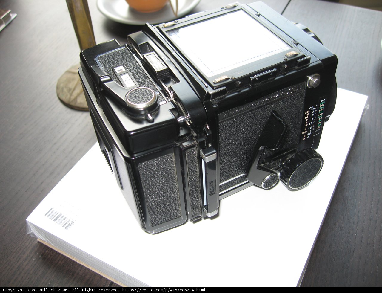 Sleek Digital Camera on White Box