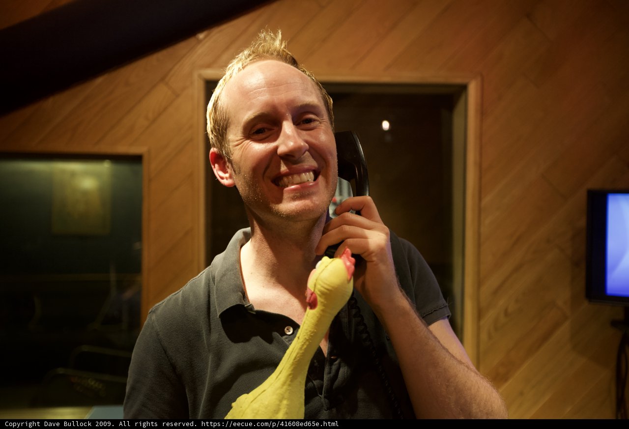 Man with Yellow Stuffed Animal in Recording Studio