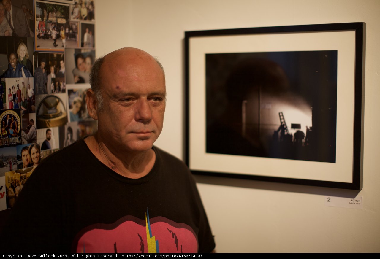 Man Standing in Front of a Portrait