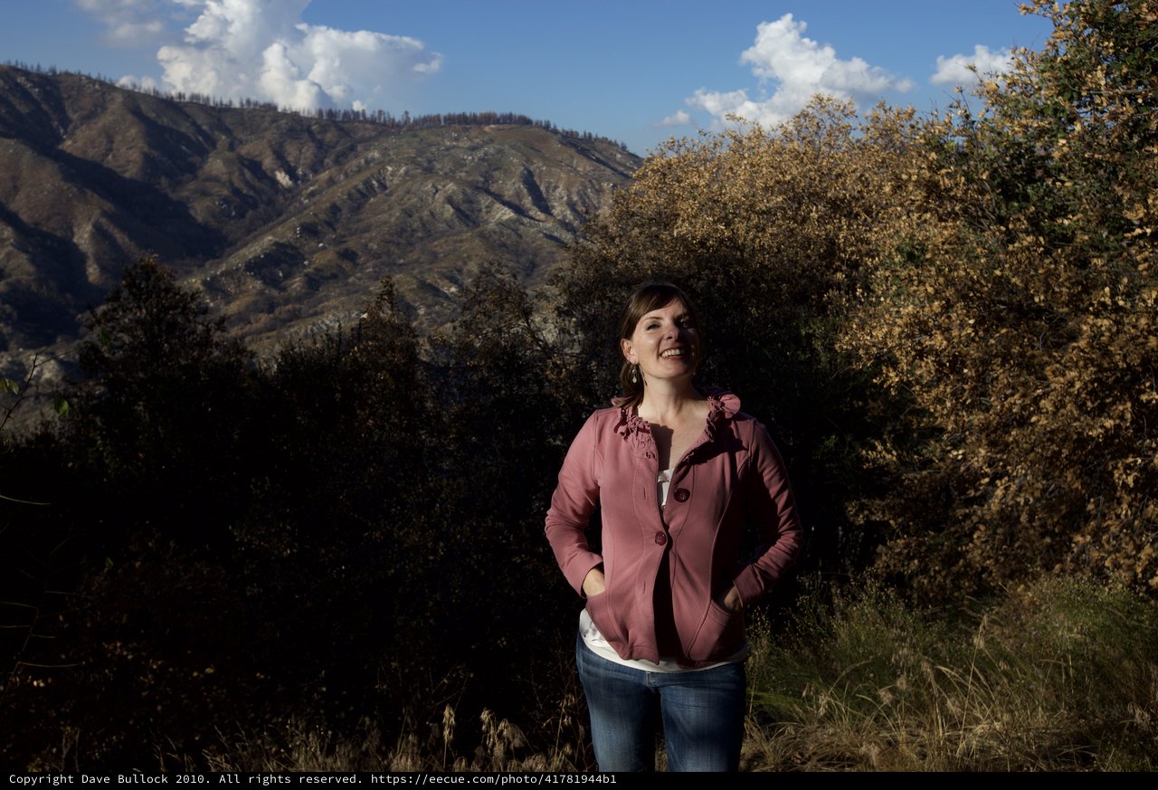 Woman Smiling Against Burnt Mountain Landscape
