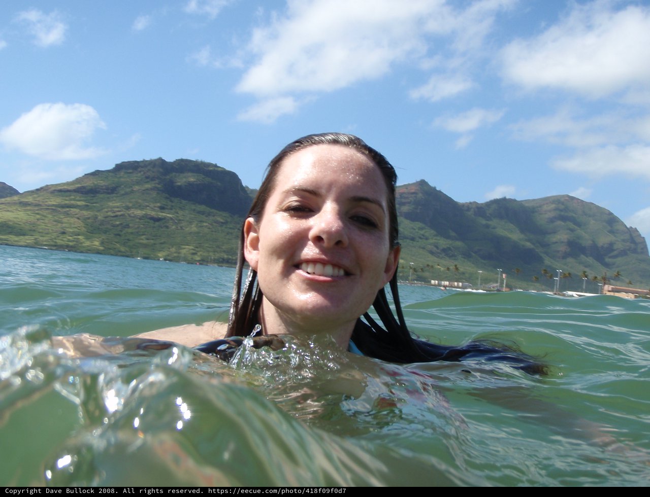 Smiling Woman Swimming in Hawaiian Ocean Waters