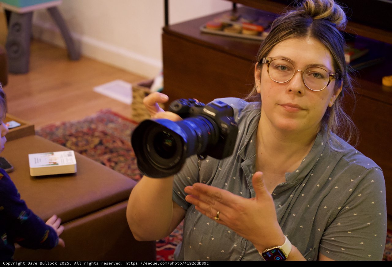 Videographer Showing Camera in Home Studio Setting