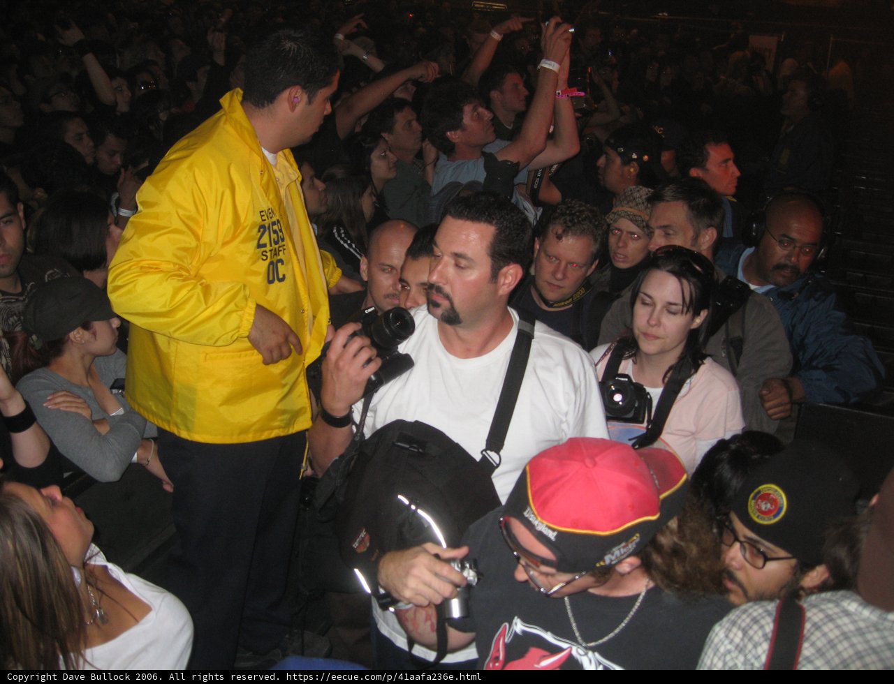 Yellow Jacket Man in the Midst of a Nightlife Crowd
