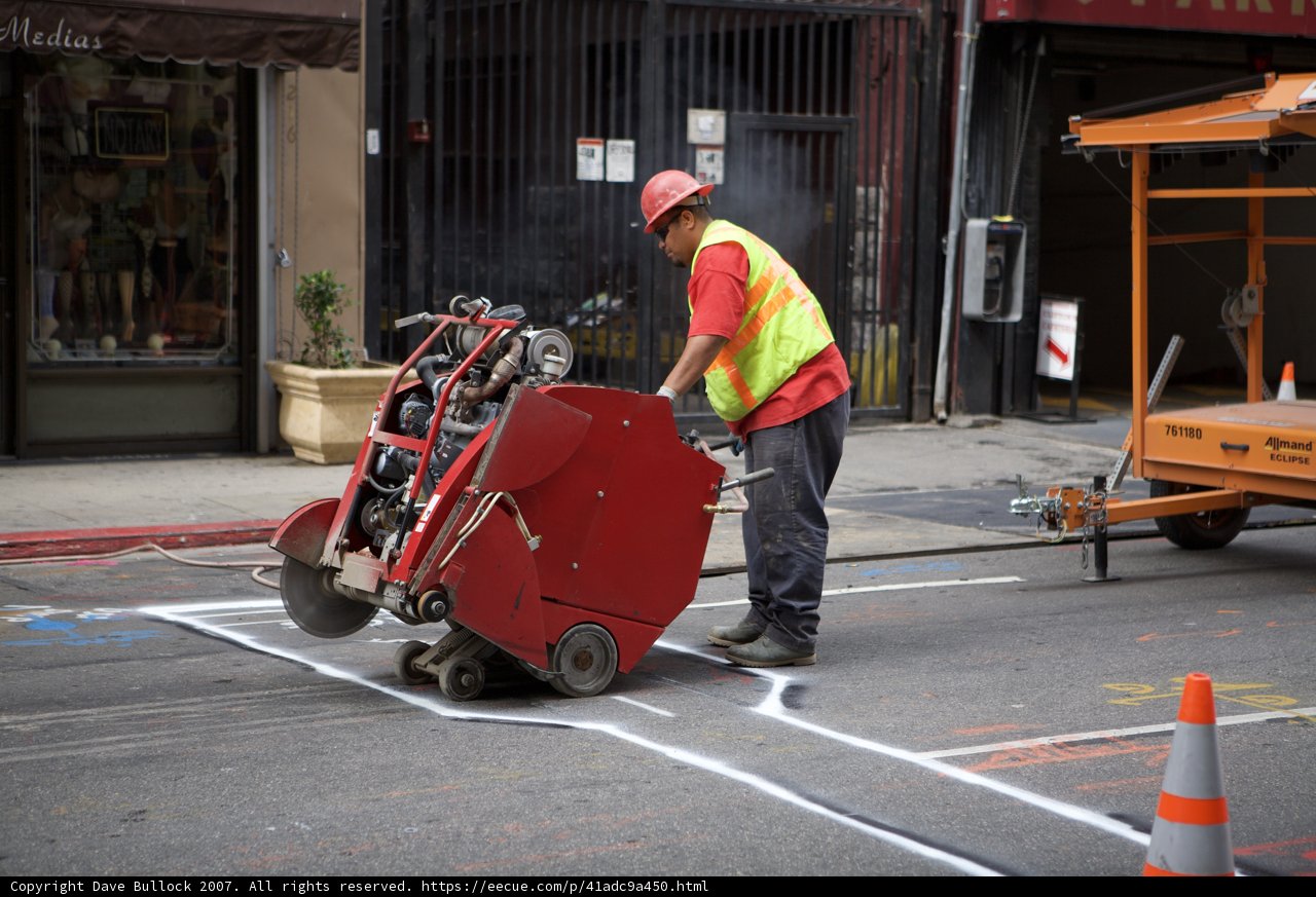 Street Worker Operating Red Machine