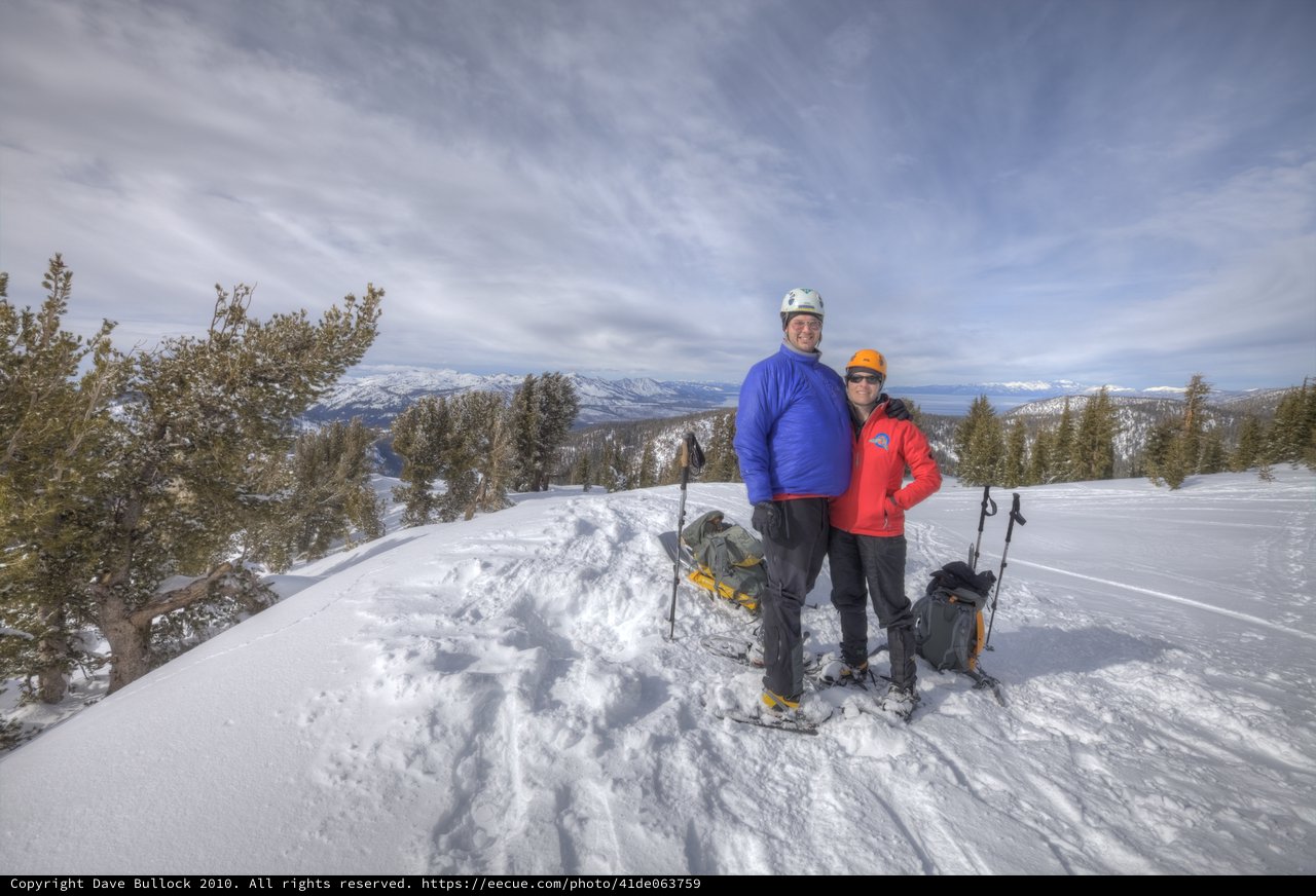 Summit Smiles: Couple Atop Snowy Sierra Nevada Peak