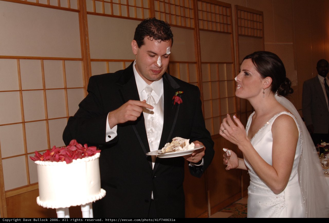 Bride and Groom Share Playful Wedding Cake Moment