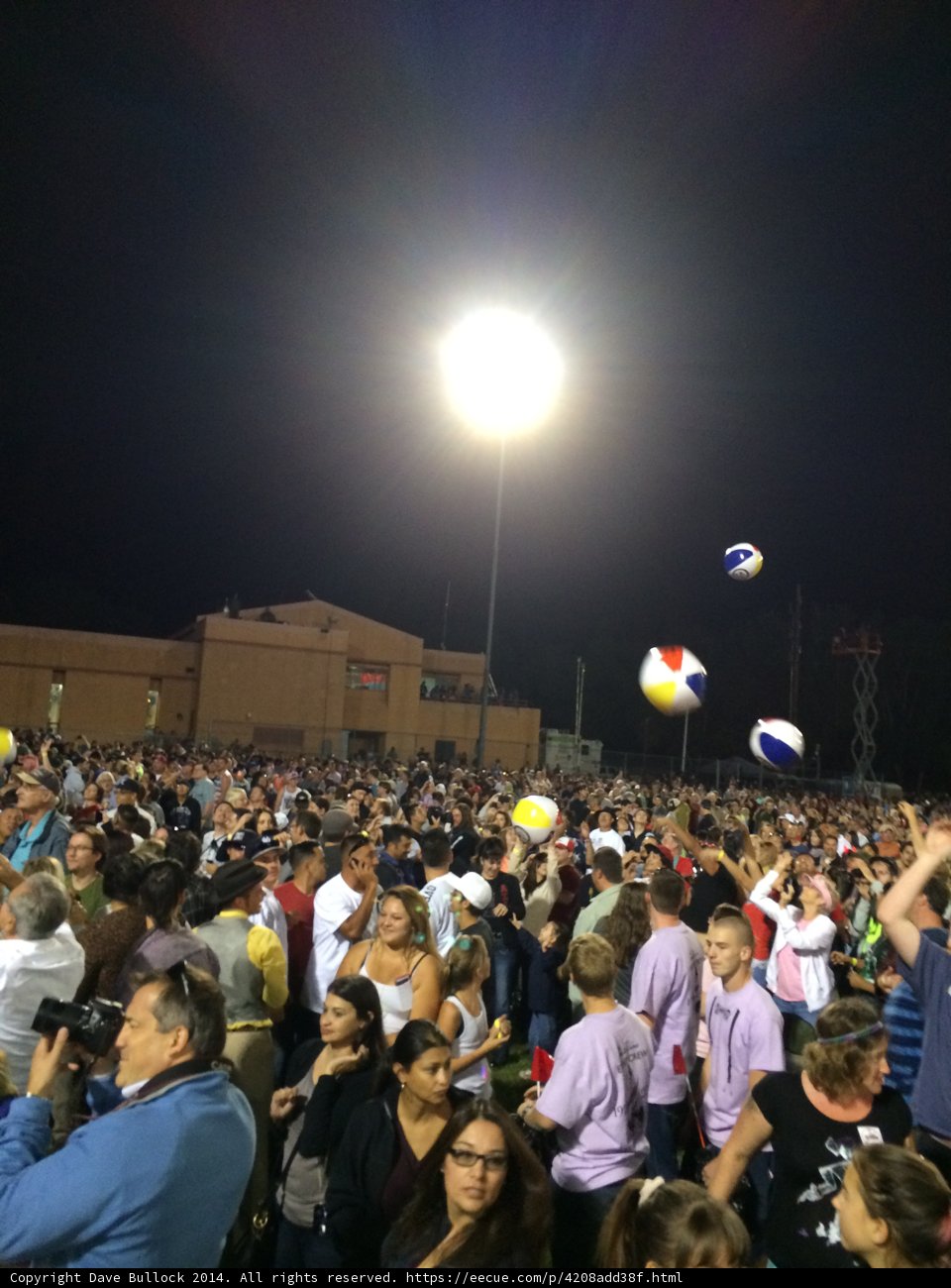 Nighttime Volleyball Game with a Lively Crowd