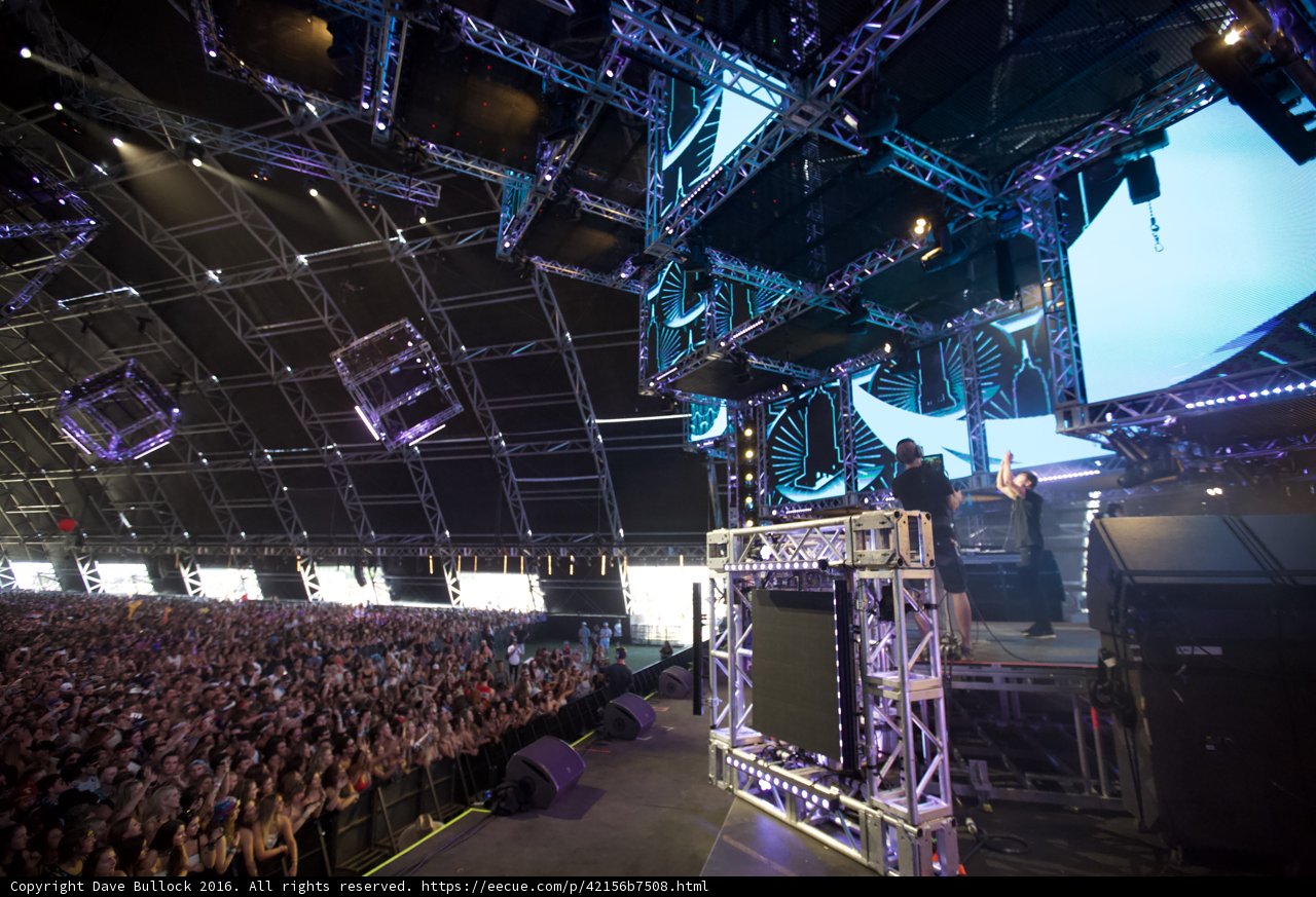 The Epic Stage Show Caption: The massive stage, blazing lights and thundering crowd make for an unforgettable concert experience at Coachella 2016.