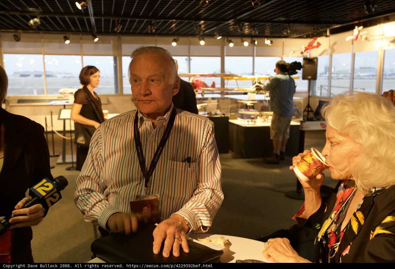 Buzz Aldrin Conversing with a Companion at a Restaurant