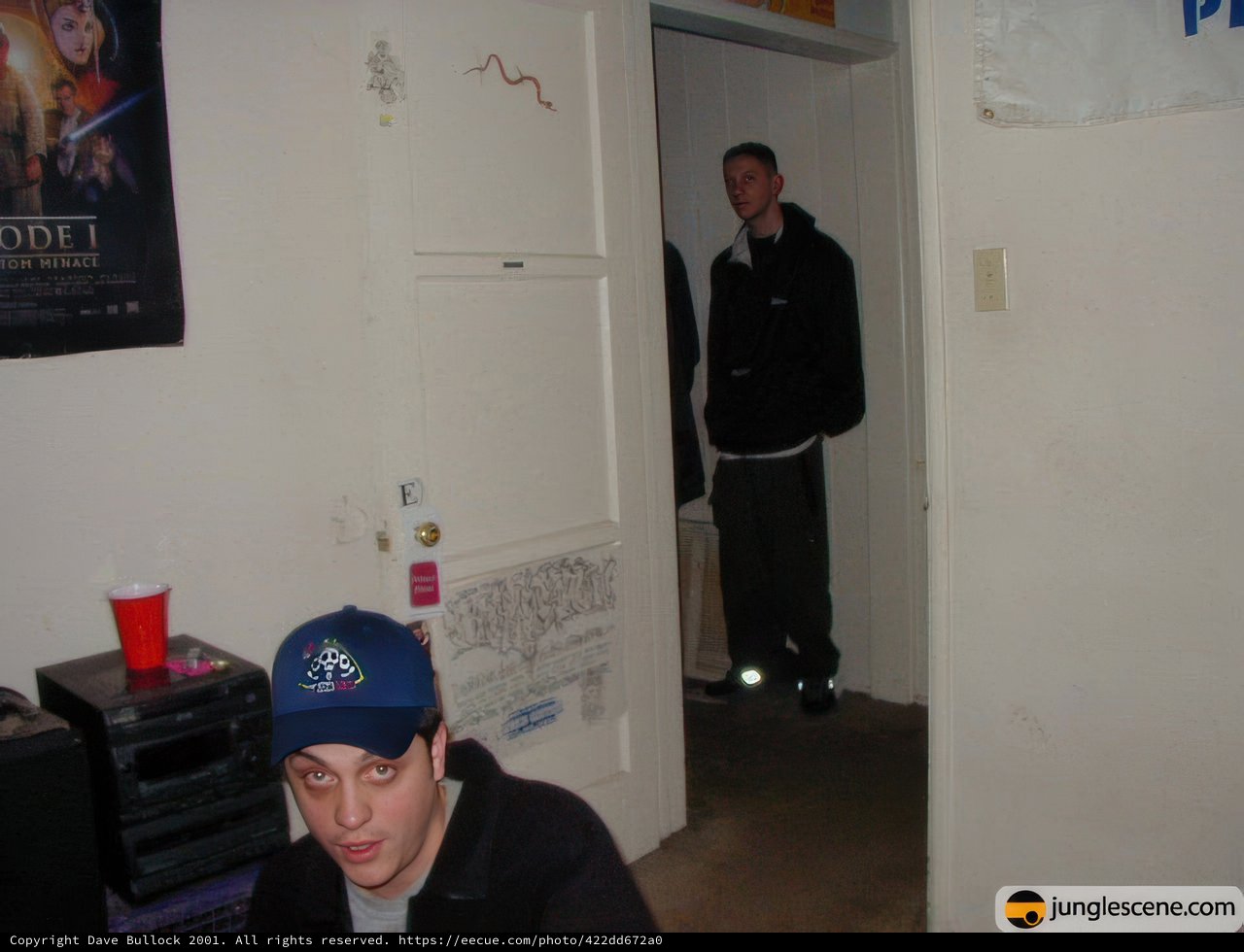 Alan W Sports His Black Jacket and Baseball Cap