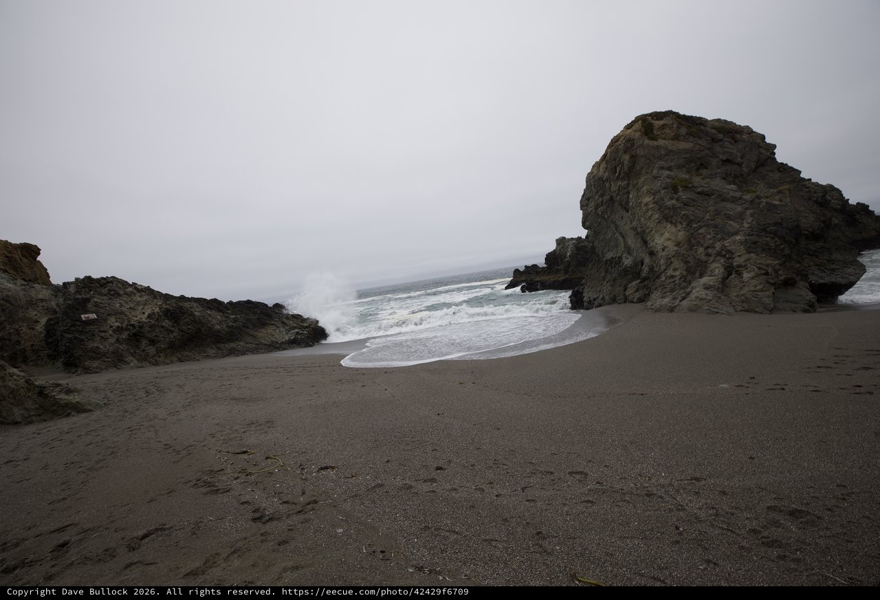 Rugged Cove Where Wild Waves Meet Dark Sand