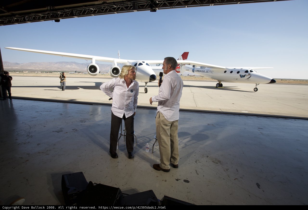 Richard Branson and Companion in Front of White Knight Two at Airfield